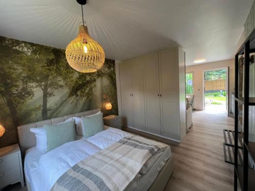 a bedroom with a bed and a painting on the wall at Bungalow Green Park in Benz