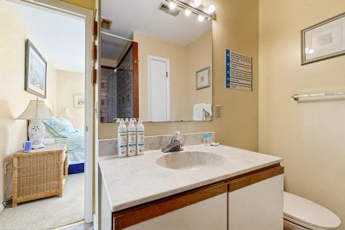 a bathroom with a sink and a toilet and a mirror at Indian Harbor Villas -- 31 Indian Harbor in Bethany Beach