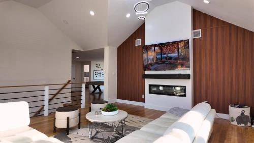 a living room with a white couch and a fireplace at Catskills Escape Hot Tub Massage Chairs & Games in Round Top