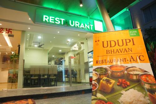 a sign in front of a restaurant with food at KVP GOLDEN INN in Tirupati