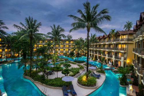 an aerial view of a resort with a pool and palm trees at Phuket Marriott Resort & Spa, Merlin Beach in Patong Beach