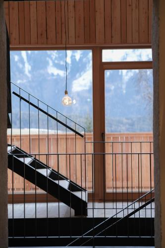a staircase in a room with a large window at das 1494 Wohnen und Kultur im Denkmal in Mieming