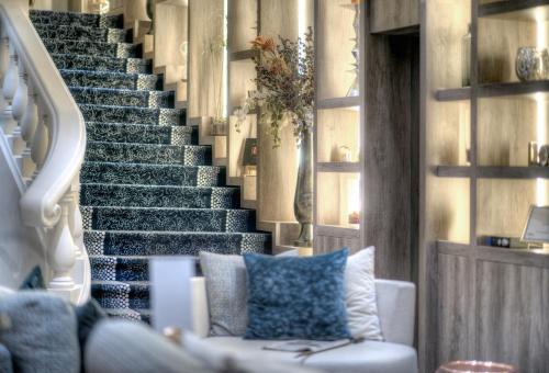 a living room with a couch and a staircase at Best Western Plus Nice Cosy Hotel in Nice