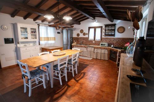 Una cocina con una mesa y sillas de madera. en Casa Iriai, en Dorgali