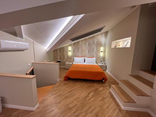 a bedroom with a bed with an orange blanket at B&B Poggio San Luca in Bologna