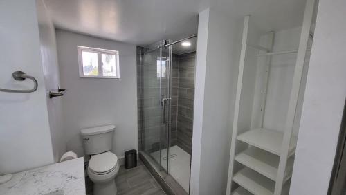 a bathroom with a toilet and a glass shower at Waterside Serenity in Hudson