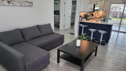 a living room with a couch and a table at Waterside Serenity in Hudson