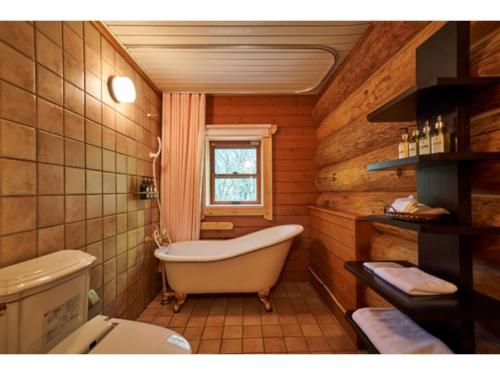a bathroom with a bath tub and a toilet at Fiore Shima - Vacation STAY 25660v in Shima