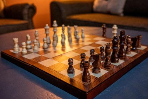 a chess set on a wooden chess board on a table at Howls Hollow by Avada Properties in Sevierville