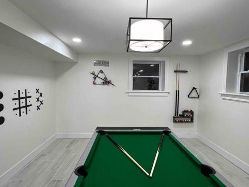a room with a green pool table in it at Modern getaway in Catskills in Cairo