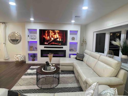 a living room with a white couch and a fireplace at Modern getaway in Catskills in Cairo