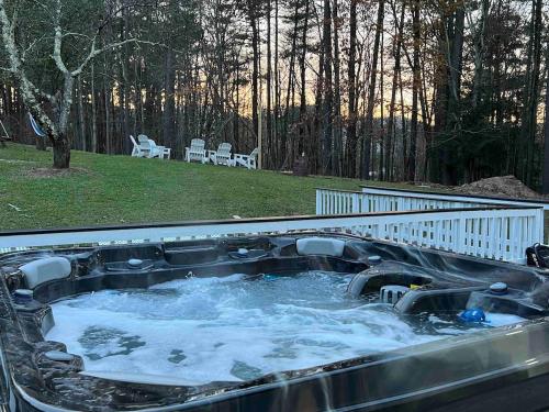 a hot tub with water in it in a backyard at Modern getaway in Catskills in Cairo