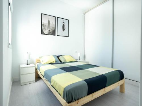 a bedroom with a large bed in a white room at Atico con terraza in La Listada