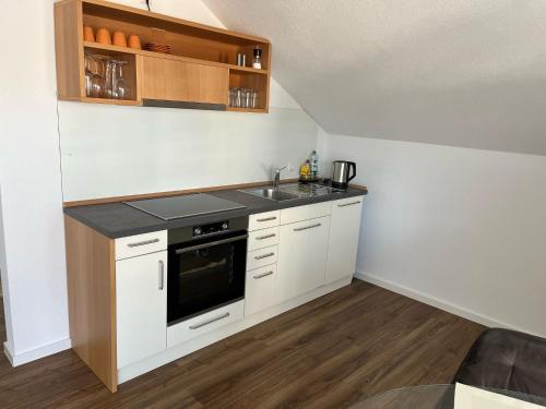 a small kitchen with a sink and a stove at Mevan Ferienwohnung in Gaienhofen
