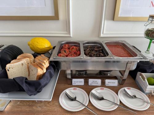 a table with a tray of food and plates of food at The Beach House in Birżebbuġa