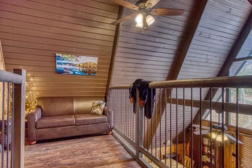 a porch with a couch and a ceiling fan at Honey Bear Slopes by Avada Properties in Gatlinburg