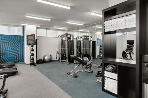 a gym with several treadmills and machines in it at Aloft Indianapolis Downtown in Indianapolis