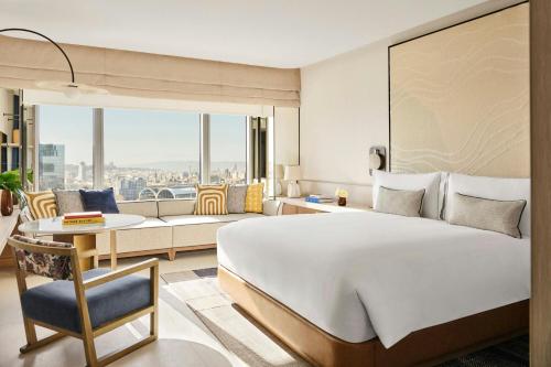 a hotel room with a large bed and a couch at Hotel Arts Barcelona in Barcelona
