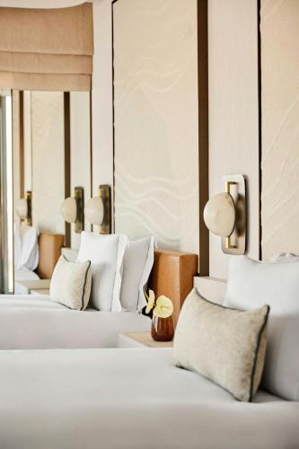 a row of beds in a hotel room at Hotel Arts Barcelona in Barcelona