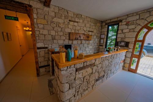 a stone kitchen with a counter in a stone wall at MorAnka Alaçatı in Alacati