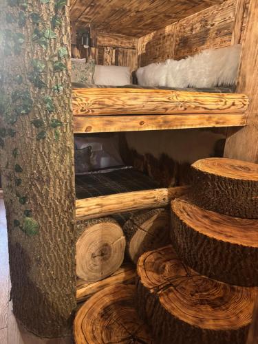 a room with a bunk bed and some logs at Mała Bawaria in Zakopane