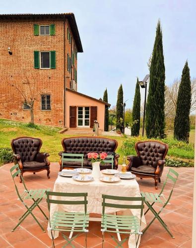 a patio with a table and chairs and a building at Dimora Gentile BnB in Castiglione del Lago