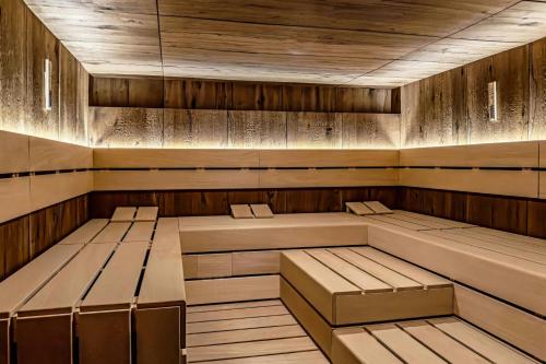a sauna with benches and tables in a room at W Prague in Prague