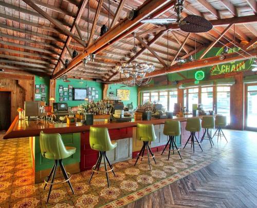 a bar with green bar stools in a restaurant at 2 Bedroom Apartment Free Reserved Parking in Miami