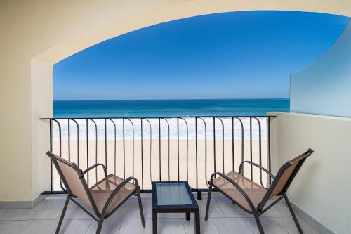 two chairs and a table on a balcony with the ocean at Krystal Grand Los Cabos - All Inclusive in San José del Cabo