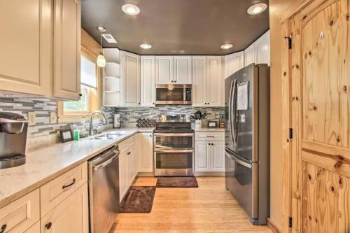 a kitchen with white cabinets and stainless steel appliances at Heaven in the Smokies 3 by Avada Properties in Gatlinburg