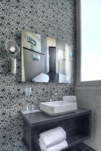 a bathroom with a sink and a mirror at Best Western Plus Nice Cosy Hotel in Nice