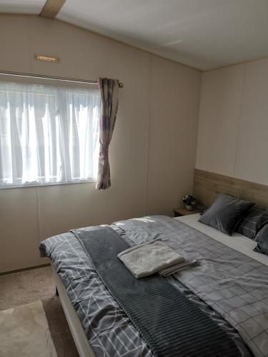a bedroom with a large bed and a window at Nikola in Skegness