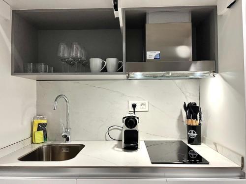 a kitchen with a sink and a counter top at Luxury in the centre of Murcia in Murcia