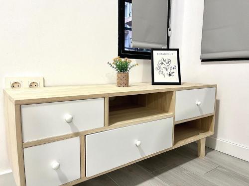 a wooden dresser with drawers and a mirror at Luxury in the centre of Murcia in Murcia