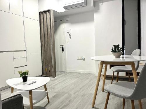 a room with two tables and chairs and a hallway at Luxury in the centre of Murcia in Murcia