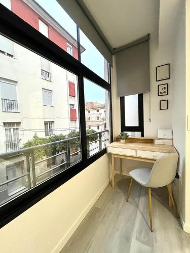 a desk in a room with a large window at Luxury in the centre of Murcia in Murcia