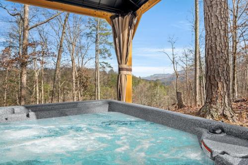 a hot tub in the middle of a forest at Grassy Paradise by Avada Properties in Sevierville