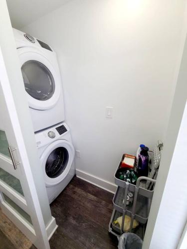 a laundry room with a washing machine in it at Charlies by the Bay Unit 4 in New Baltimore