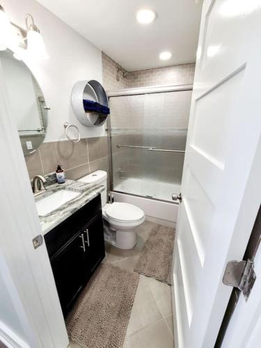 a bathroom with a toilet and a sink and a shower at Charlies by the Bay Unit 4 in New Baltimore