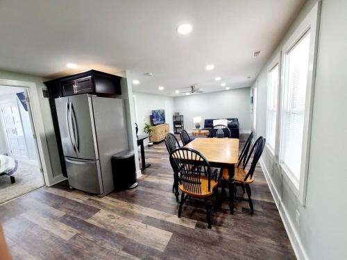 a dining room with a table and a refrigerator at Charlies by the Bay Unit 4 in New Baltimore