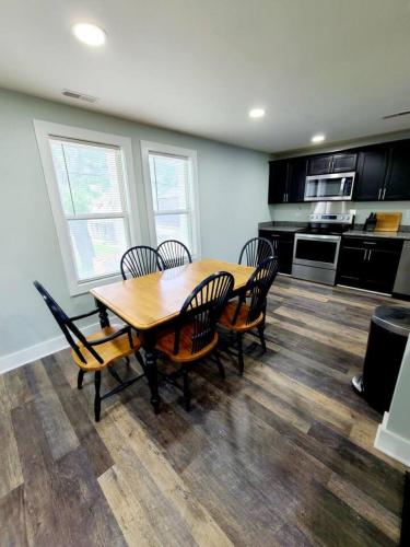 a dining room with a wooden table and chairs at Charlies by the Bay Unit 4 in New Baltimore