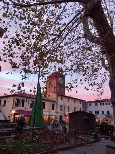 a building with a clock tower in front of it at CHIC house in Cascina