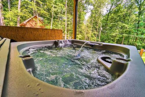 a jacuzzi tub with a water fountain in it at Smoky Mtns Private w/Hot Tub, Game Room, Pets Free in Sevierville