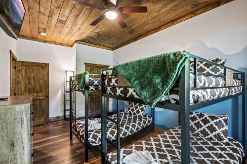 two bunk beds in a room with a ceiling fan at Smoky Mtns Private w/Hot Tub, Game Room, Pets Free in Sevierville