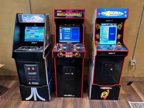 three arcade video game machines sitting next to each other at Smoky Mtns Private w/Hot Tub, Game Room, Pets Free in Sevierville