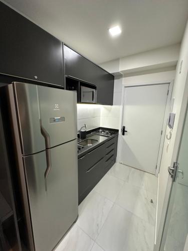a kitchen with a stainless steel refrigerator and a sink at Compact Time apto 406 Lindo Flat in João Pessoa