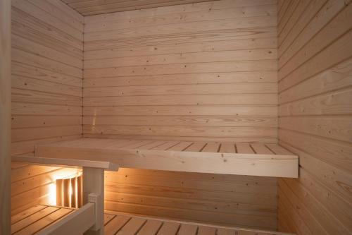 a wooden sauna with a bench in it at Convenient Apartment for 5 with Sauna in Kirkkonummi