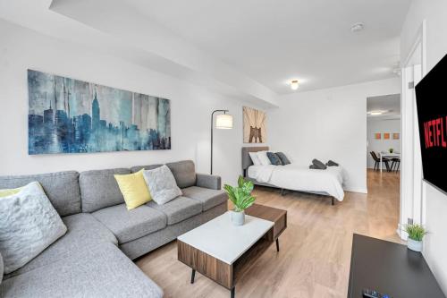 a living room with a couch and a table at Cozy Condo Near Restaurant TTC in Toronto