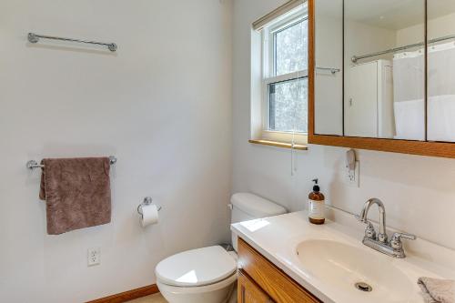 a bathroom with a toilet and a sink and a mirror at Private Black Hills Home with Corral Horses Welcome in Custer