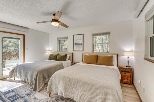 a bedroom with two beds and a ceiling fan at Private Black Hills Home with Corral Horses Welcome in Custer